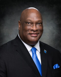 Johnny Tillett, Vice Chair of the Board of Trustees, smiling in headshot