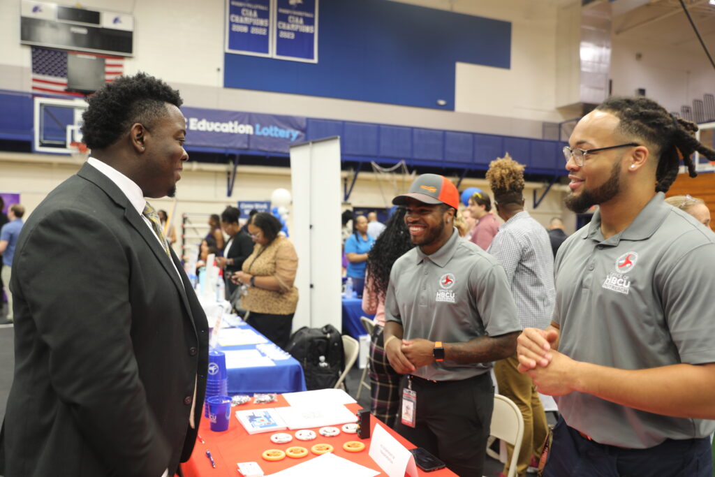 Student in suit at Career Fair stall
