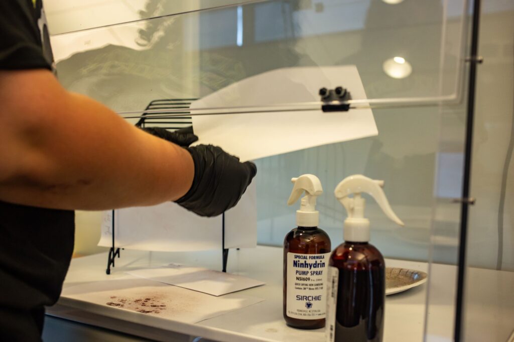 Close up of student's hands working with forensics tools