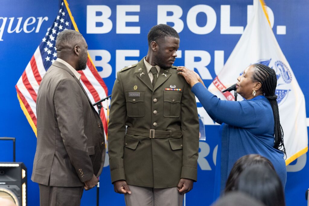 An ECSU ROTC student at a Commissioning Ceremony being pinned by parents or guardians.