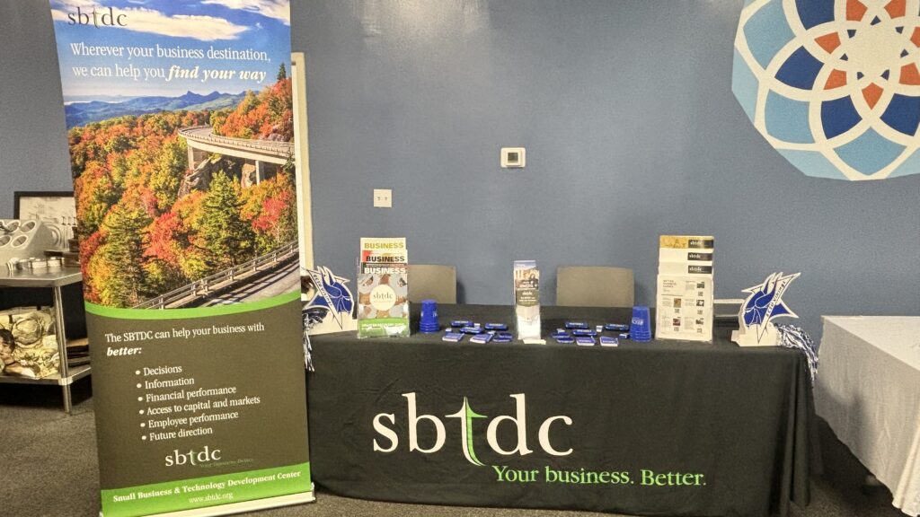 Small Business and Technology Development Center staff share resources with entrepreneurs at a business development event.
