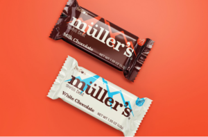 Chocolate bar packaging design for Helio’s featuring milk chocolate and white chocolate wrappers. The design uses bold typography, geometric accents, and contrasting brown and blue color palettes displayed on an orange background.